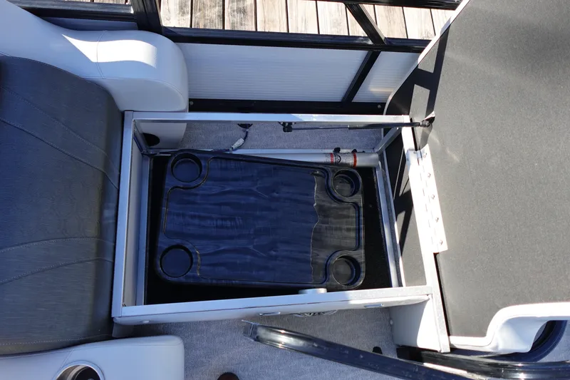 Slide: The Image of 2020 Tahoe Pontoon 2485 LTZ Rear Lounger storage compartment with cup holders. - 19