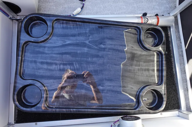 Slide: The Image of 2020 Tahoe Pontoon 2485 LTZ Rear Lounger cup holder tray with reflective surface. - 20