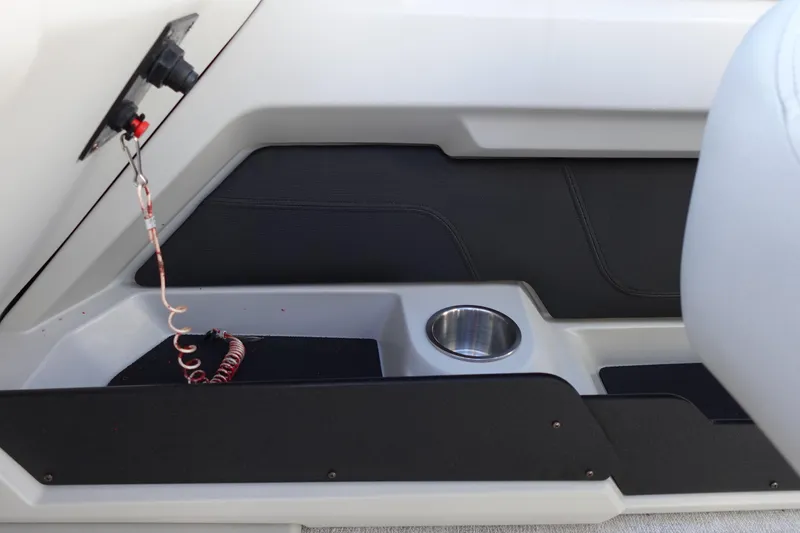 Slide: The Image of 2020 Tahoe Pontoon 2485 LTZ Rear Lounger interior detail with cup holder and control panel. - 25