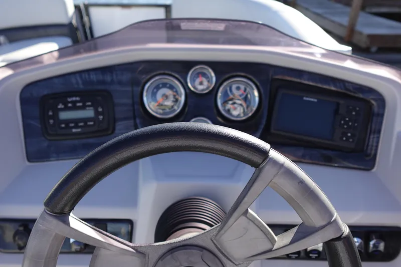 Slide: The Image of Steering wheel and dashboard of 2020 Tahoe Pontoon 2485 LTZ Rear Lounger boat. - 32