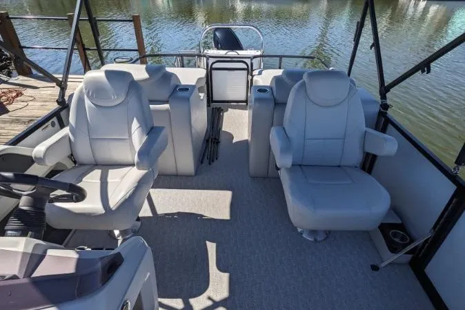 Slide: The Image of 2020 Tahoe Pontoon 2485 LTZ Rear Lounger with plush seating on calm water. - 4
