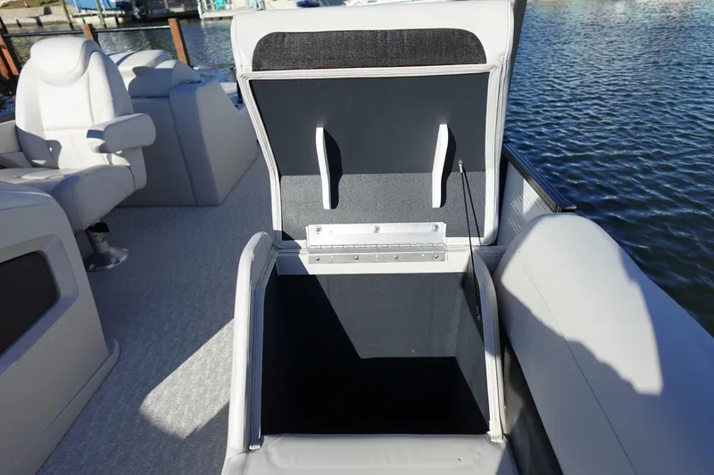 Slide: The Image of 2020 Tahoe Pontoon 2485 LTZ Rear Lounger with open storage compartment on a sunny day. - 40