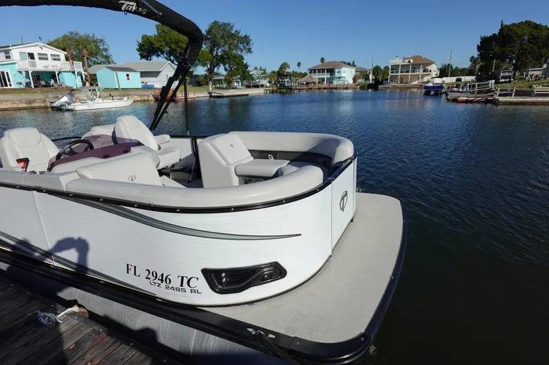 Slide: The Image of 2020 Tahoe Pontoon 2485 LTZ Rear Lounger on a serene waterfront dock. - 44