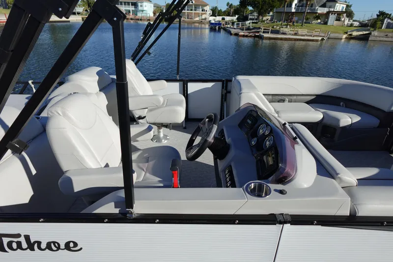 Slide: The Image of 2020 Tahoe Pontoon 2485 LTZ Rear Lounger on water, featuring luxurious seating and modern dashboard. - 46