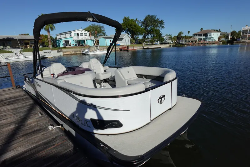 Slide: The Image of 2020 Tahoe Pontoon 2485 LTZ Rear Lounger docked by waterfront homes. - 49