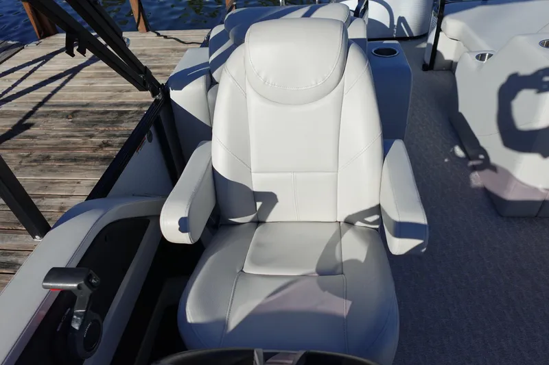 Slide: The Image of 2020 Tahoe Pontoon 2485 LTZ Rear Lounger captain's chair on a wooden dock. - 5