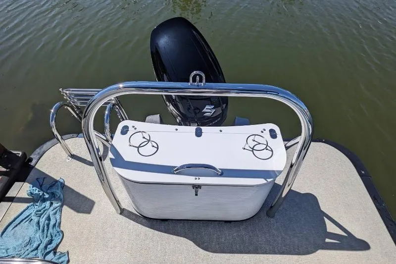 Slide: The Image of 2020 Tahoe Pontoon 2485 LTZ Rear Lounger with motor, docked on calm water. - 52