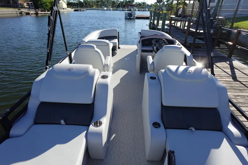 Slide: The Image of 2020 Tahoe Pontoon 2485 LTZ Rear Lounger on a serene lake dock. - 8