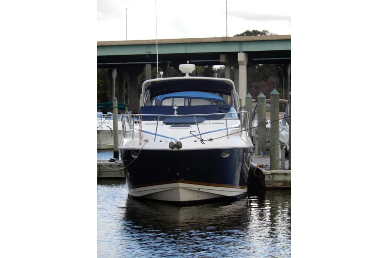 Slide: The Image of 2005 Rinker 360 Express Cruiser docked at marina, front view. - 1