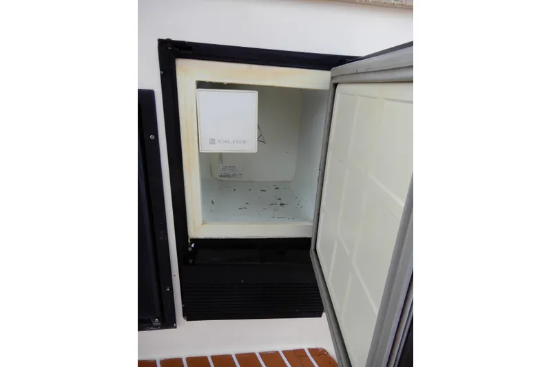 Slide: The Image of Open U-Line refrigerator on 2005 Rinker 360 Express Cruiser boat. - 13