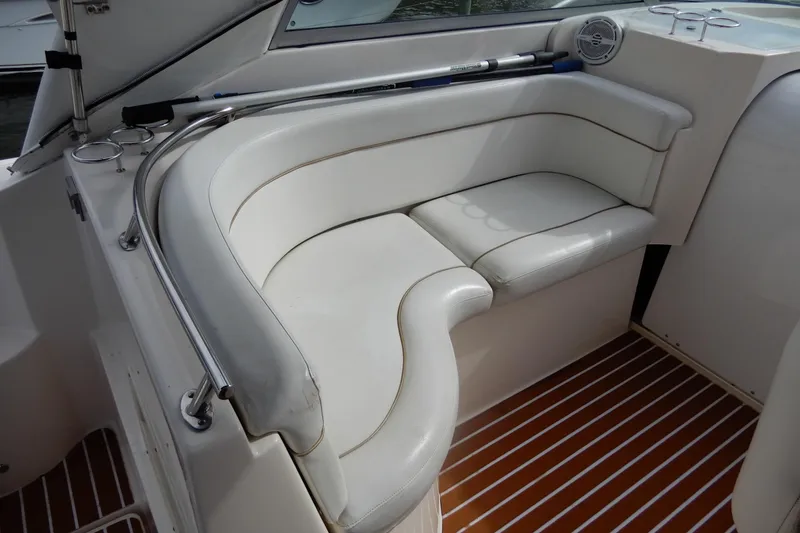 Slide: The Image of 2005 Rinker 360 Express Cruiser interior with white leather seating and wood-patterned flooring. - 14