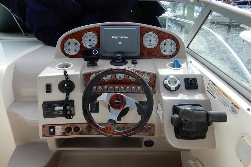 Slide: The Image of 2005 Rinker 360 Express Cruiser helm with Raymarine navigation and control panel. - 17