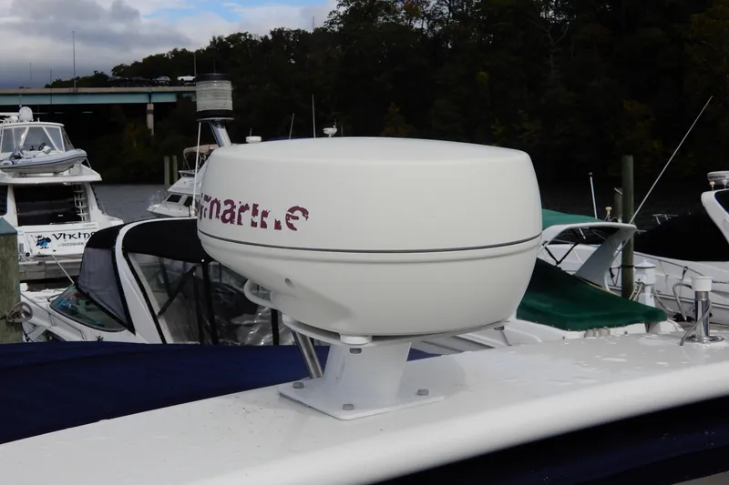 Slide: The Image of Radar equipment on a 2005 Rinker 360 Express Cruiser docked near other boats. - 18