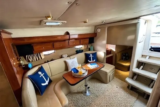 Slide: The Image of 2005 Rinker 360 Express Cruiser interior with cozy seating and nautical decor. - 19