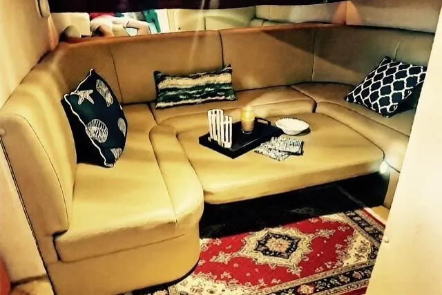 Slide: The Image of 2005 Rinker 360 Express Cruiser interior with cozy seating and decorative pillows. - 22