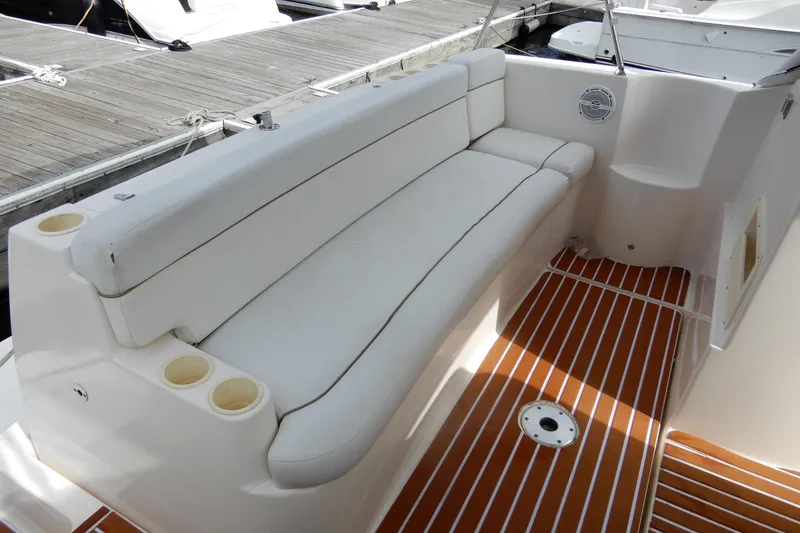 Slide: The Image of 2005 Rinker 360 Express Cruiser interior with white seating and wood-patterned flooring. - 8