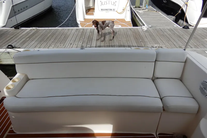 Slide: The Image of 2005 Rinker 360 Express Cruiser with white seating and dock view. - 9