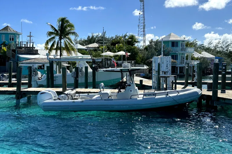 The Image of Zodiac 850 boat docked at a tropical marina, clear blue water, palm trees, 2014 model. - 1
