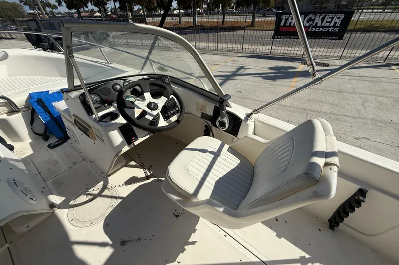 Slide: The Image of 2002 Boston Whaler Ventura 160 boat interior with steering wheel and seating. - 10