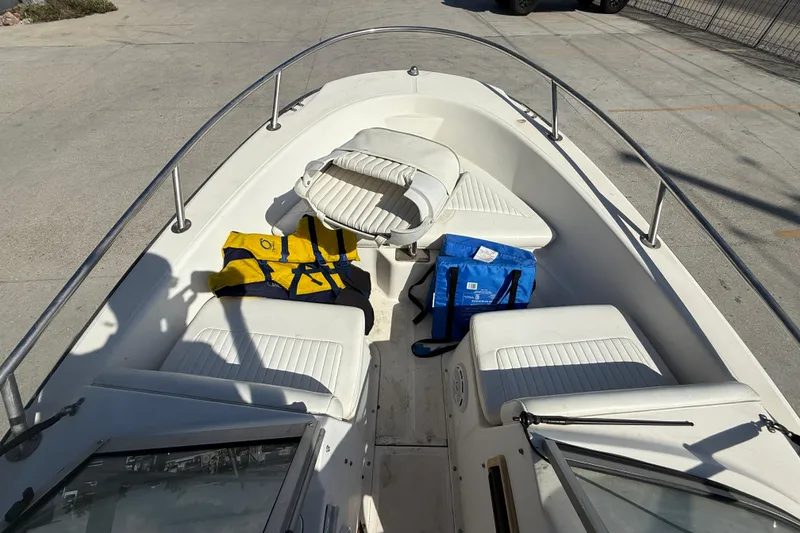 Slide: The Image of 2002 Boston Whaler Ventura 160 boat interior with life jackets and seating. - 11