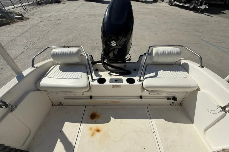 Slide: The Image of 2002 Boston Whaler Ventura 160 boat interior with seating and motor. - 13