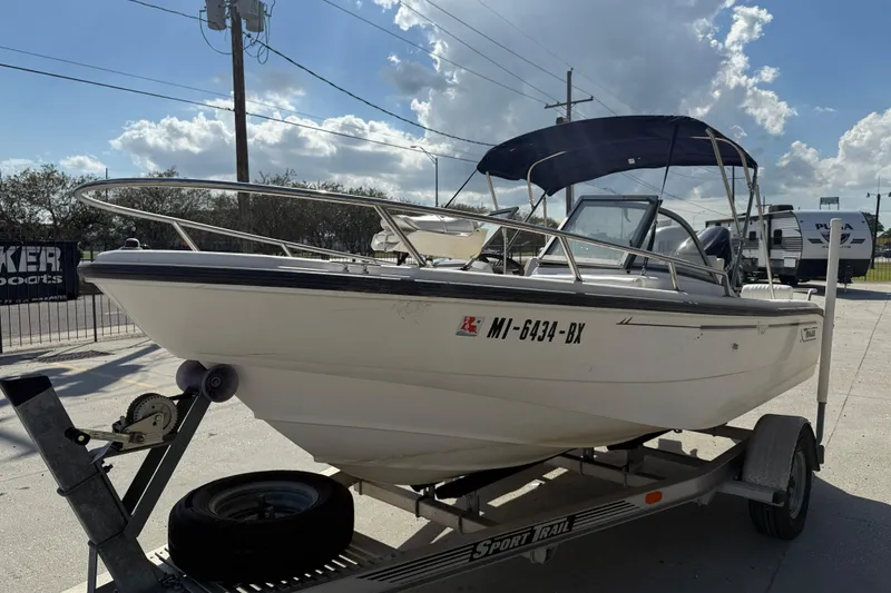Slide: The Image of 2002 Boston Whaler Ventura 160 boat on trailer under clear sky. - 4