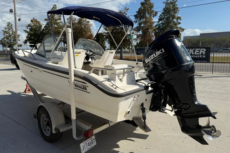 Slide: The Image of 2002 Boston Whaler Ventura 160 boat with Suzuki outboard motor on trailer. - 5