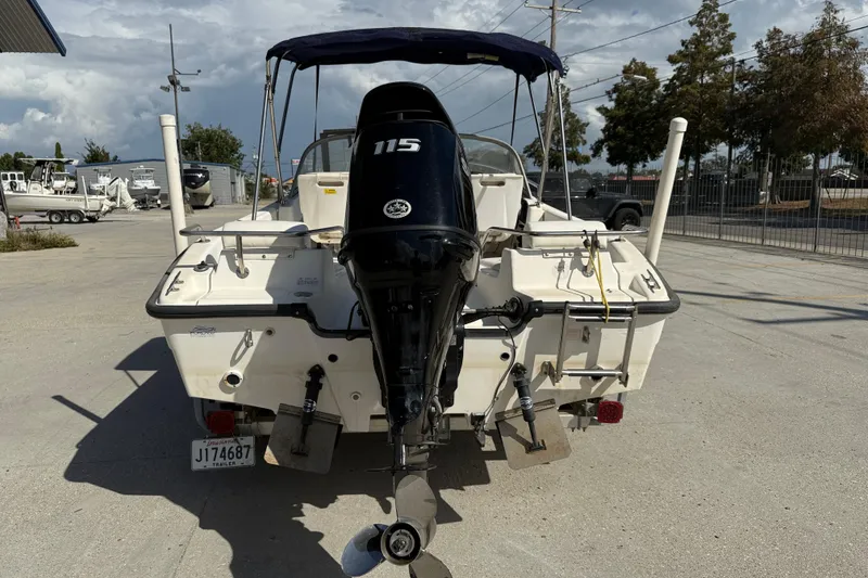 Slide: The Image of 2002 Boston Whaler Ventura 160 boat with 115 HP engine, parked outdoors. - 6