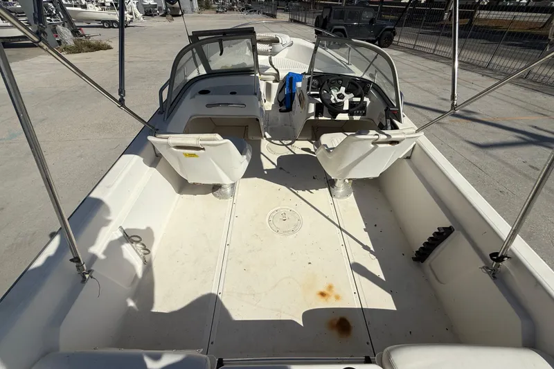 Slide: The Image of 2002 Boston Whaler Ventura 160 boat interior with seating and steering wheel. - 8