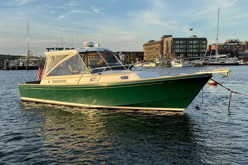 The Image of 2000 Little Harbor Whisper Jet 34 boat on calm water, cityscape background. - 0