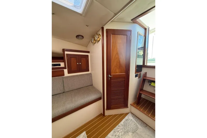 Slide: The Image of Interior of 2000 Little Harbor Whisper Jet 34, featuring wooden cabinetry and seating. - 12