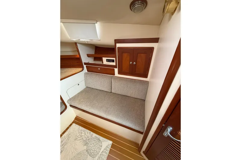 Slide: The Image of Interior of 2000 Little Harbor Whisper Jet 34 with cushioned seating and wooden cabinetry. - 17