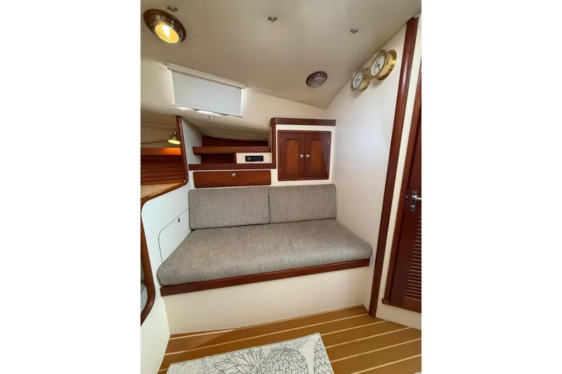 Slide: The Image of Interior of 2000 Little Harbor Whisper Jet 34, featuring cozy seating and wooden cabinetry. - 19