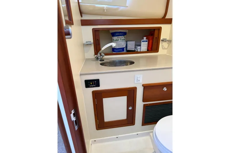 Slide: The Image of Little Harbor Whisper Jet 34 (2000) bathroom with sink, storage, and toilet essentials. - 21