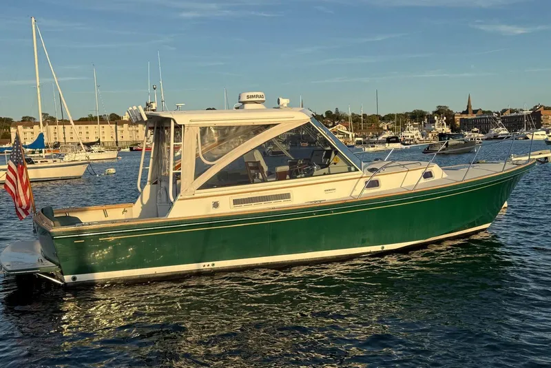 Slide: The Image of 2000 Little Harbor Whisper Jet 34 boat on calm water, with American flag. - 23
