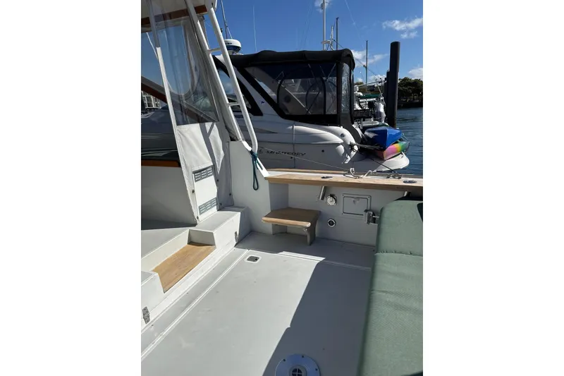 Slide: The Image of Little Harbor Whisper Jet 34, 2000 model, docked with visible seating and deck area. - 3