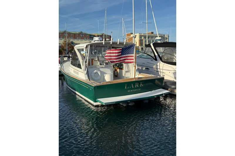 Slide: The Image of Little Harbor Whisper Jet 34, 2000 model, docked with American flag, Newport, RI. - 31