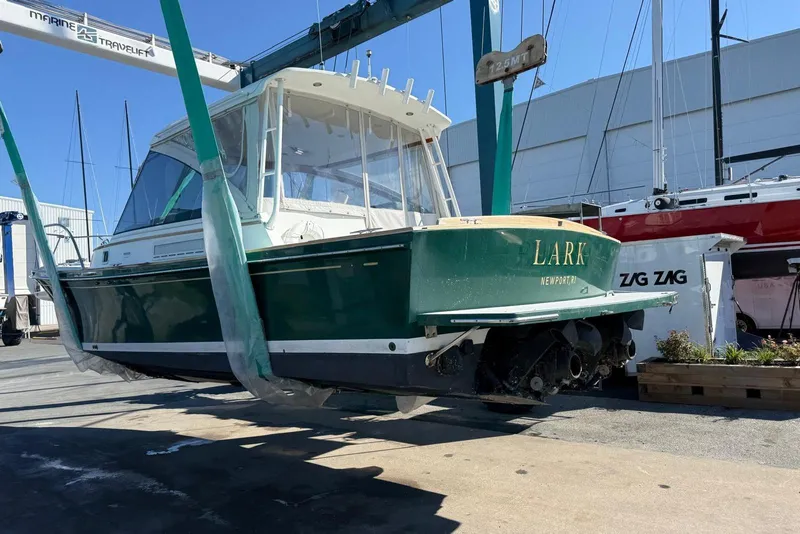 Slide: The Image of 2000 Little Harbor Whisper Jet 34 boat lifted at a marina. - 34