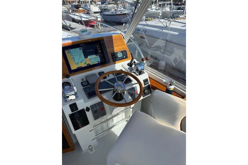 Slide: The Image of Helm of 2000 Little Harbor Whisper Jet 34 with navigation equipment and steering wheel. - 5