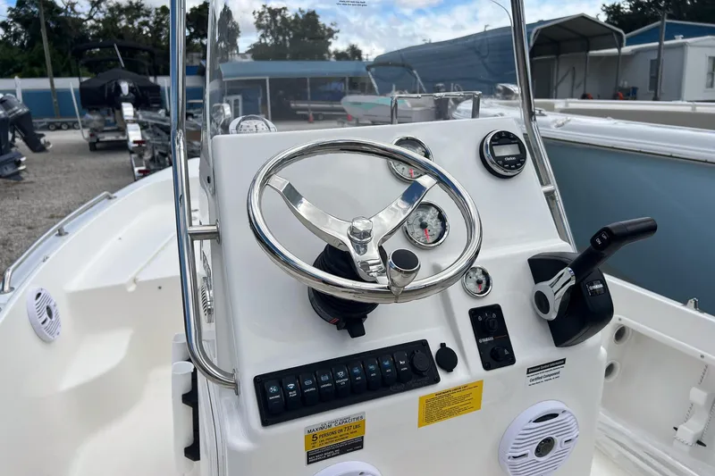 Slide: The Image of 2026 Key West 1720 Center Console boat dashboard with steering wheel and controls. - 4