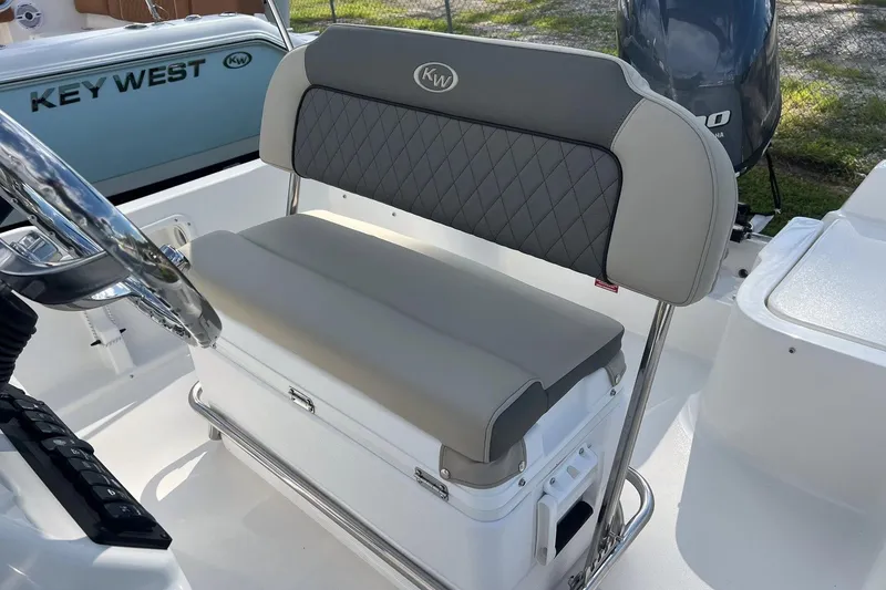 Slide: The Image of 2026 Key West 1720 Center Console boat interior with cushioned seating and steering wheel. - 8