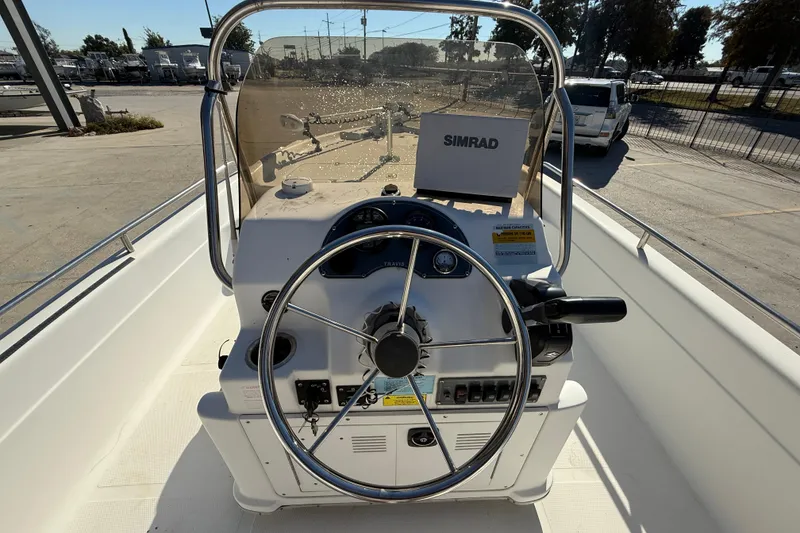 Slide: The Image of 2002 Fishmaster 196 Travis Edition boat console with steering wheel and Simrad navigation system. - 12