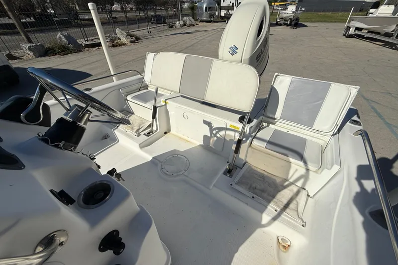 Slide: The Image of 2002 Fishmaster 196 Travis Edition boat interior with steering wheel and seating. - 13