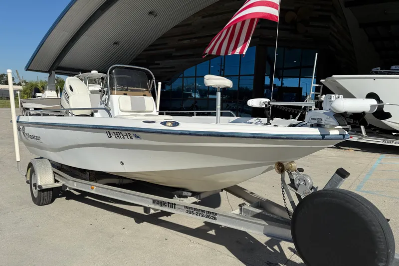 Slide: The Image of 2002 Fishmaster 196 Travis Edition boat on trailer with American flag. - 3