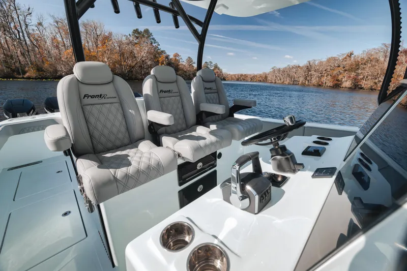 Slide: The Image of Luxurious 2026 Front Runner 37' Catamaran interior with plush seating and modern controls on a scenic river. - 16