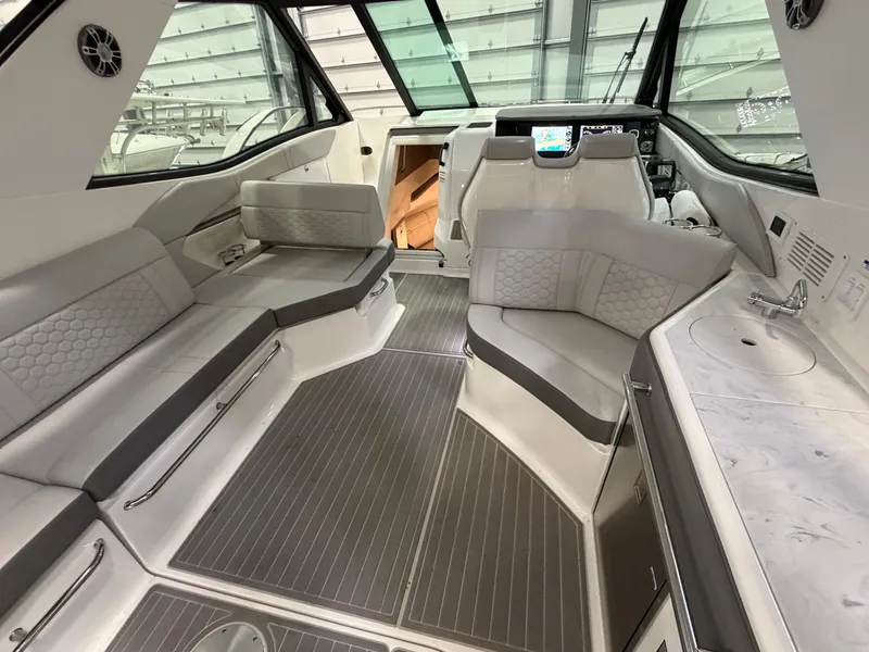 Slide: The Image of 2023 Sea Ray Sundancer 320 Outboard interior with luxurious seating and modern amenities. - 10