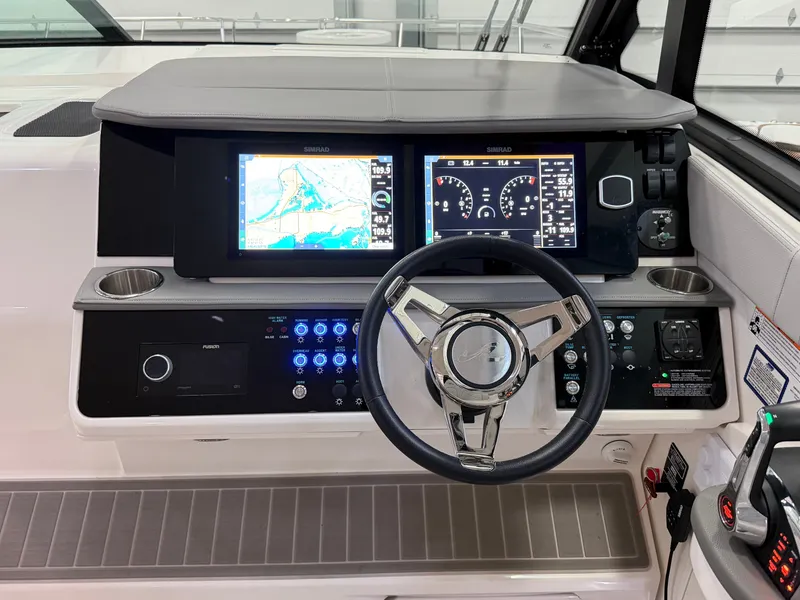 Slide: The Image of 2023 Sea Ray Sundancer 320 Outboard helm with dual Simrad displays and modern controls. - 19