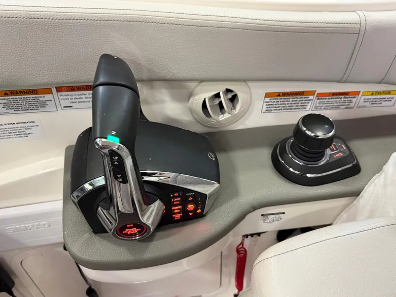 Slide: The Image of 2023 Sea Ray Sundancer 320 Outboard control panel with throttle and joystick. - 20