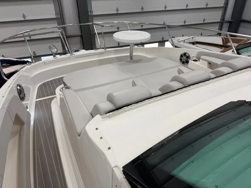 Slide: The Image of 2023 Sea Ray Sundancer 320 Outboard with spacious deck and luxurious seating in a showroom. - 22