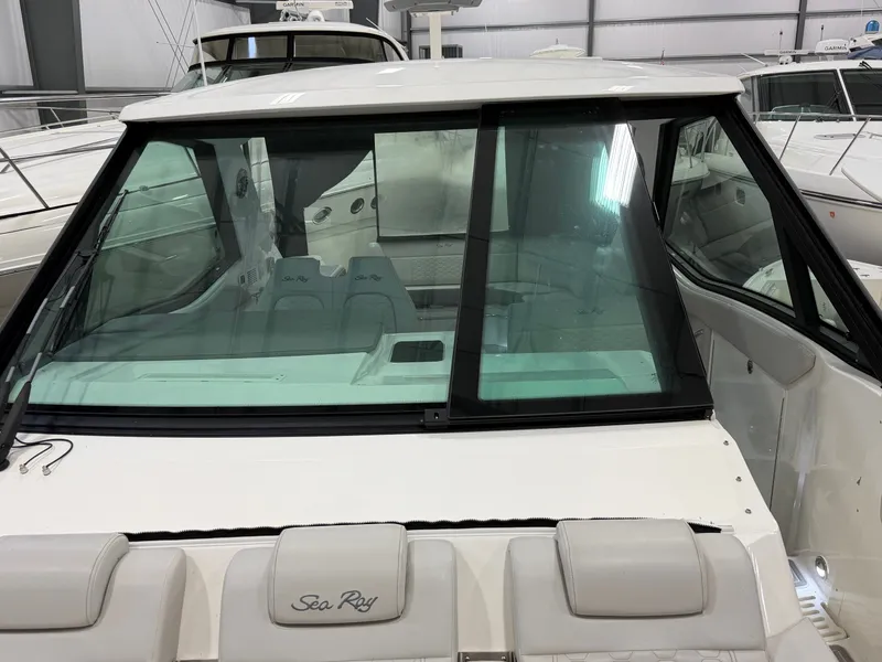 Slide: The Image of 2023 Sea Ray Sundancer 320 Outboard boat interior with windshield and seating. - 24